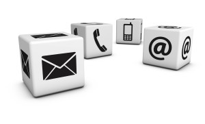 Contact us web and Internet concept with email, mobile phone and at icons and symbol on four cubes for website, blog and on line business.